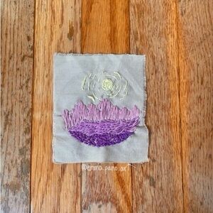 embroidered mountain sunset artwork